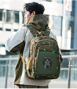 Man wearing military digital camouflage backpack with multiple zipper pockets on city street