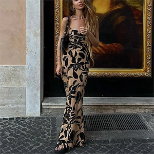 Close-up of tropical leaf print and lightweight fabric on the backless maxi dress
