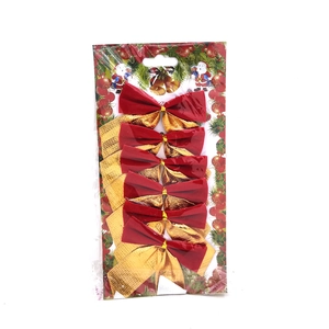 Detail view of 6-piece red and gold Christmas bows in clear retail plastic packaging