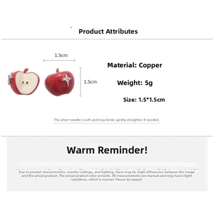 Detail showing red apple stud earrings with white flesh texture and star glitter