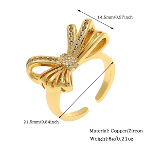 Detailed view of golden butterfly ring with cubic zirconia including size and weight specs