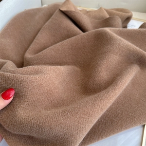 Detailed macro view of the brown cashmere-like twill fabric texture on the scarf