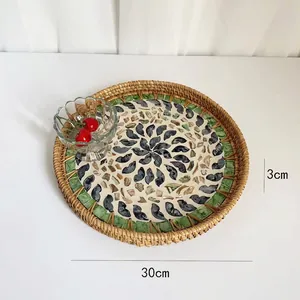 Detail of 30cm handmade rattan tray with spiral mosaic shell pattern for home decor