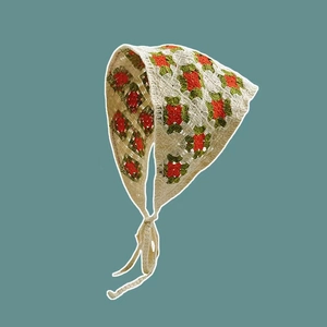 Detailed close-up of handmade crochet headscarf with vintage floral embroidery and ties