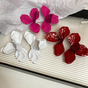 Three-color floral petal stud earrings in matte rose pink, white, and glossy deep red