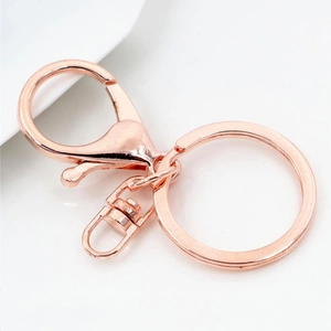 Detailed view of rose gold metal keychain parts with lobster clasp and swivel ring