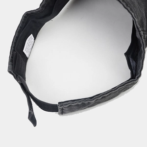 Detail view of cotton sun visor with crown embroidery and adjustable strap closure