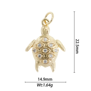 Detail of a gold turtle pendant with cubic zirconia inlay showing precise dimensions