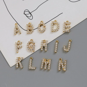 Close-up of 18k gold plated alphabet pendants A-N with sparkling zircon stones