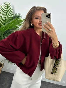 Stylish burgundy soft bomber jacket for women paired with high-waist white trousers