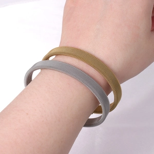 Fashionable braided titanium steel mesh bracelets in gold and silver finishes on wrist