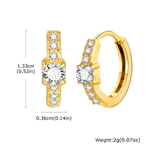 Detail view of gold stainless steel huggie earrings with multiple pavé-set zircons