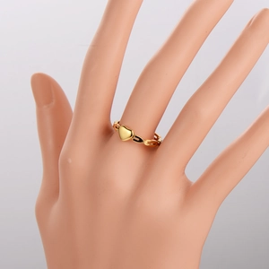 Chic hollow geometric gold stainless steel ring with polished heart on a model hand