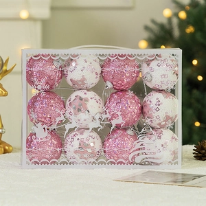 Pink and white glitter Christmas balls in a clear decorative gift box with handle