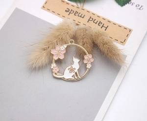 Detailed close-up of a cat and pink cherry blossom alloy pendant for DIY jewelry making