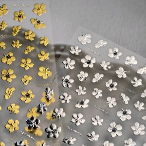 Elegant 3D floral nail stickers in gold and silver metallic finish with black accents