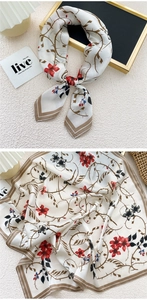 Detailed view of silk-feel square scarf featuring red floral patterns on a white base