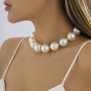 Elegant large pearl choker necklace with rhinestone spacers shown on a female model