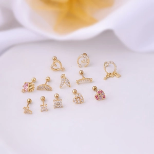 Set of gold stainless steel stud earrings featuring heart moon and wing designs with zircons