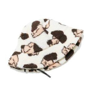 Close-up of soft plush bucket hat with brown cow spots on a clean white background