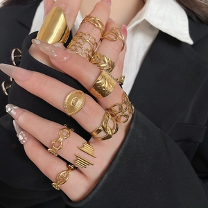Close-up of heart-shaped hollow rings stacked in gold finish on female hand