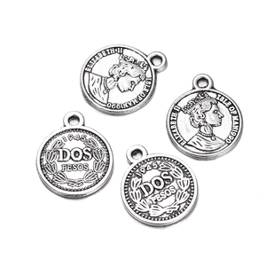 Detailed view of four antique silver coin pendants for DIY jewelry with embossed details