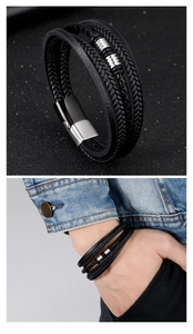 Macro detail of men's multilayer black braided leather bracelet with silver metal beads