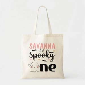 Detail of canvas tote bag featuring spooky Halloween pumpkin and ghost print patterns