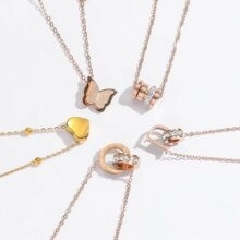 Detailed set of five rose gold necklaces with butterfly, heart, and crystal pendants