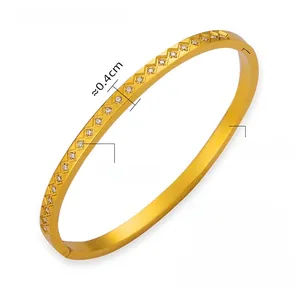 Close-up of gold titanium steel bracelet with embedded Czech diamonds on white background