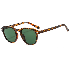 Retro tortoise shell sunglasses with dark green lenses and metal rivet accents