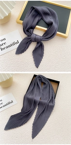 Close-up of charcoal grey pleated scarf with fine accordion folds and glossy texture