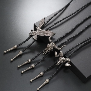 Vintage western bolo ties set featuring silver eagle and bull skull charms on black leather