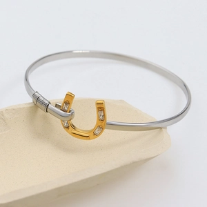 18K gold plated horseshoe bangle with sparkling cubic zirconia on stone base