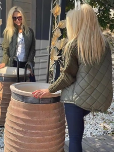 Women's army green quilted vest jacket with knit sleeves and zip-up stand collar