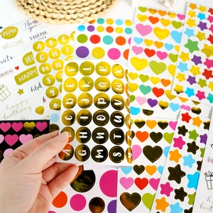 Colorful bronzing stickers set with gold letters, hearts, and stars for DIY scrapbooking