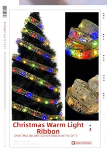 Detail of LED Christmas ribbon with gold glitter stars on tree and rolled spool
