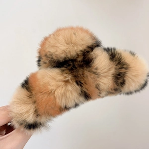Detail of large leopard print plush hair claw clip showing soft faux rabbit fur texture