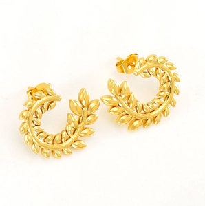 Close-up of golden wheat ear earrings with a polished C-shaped leaf design