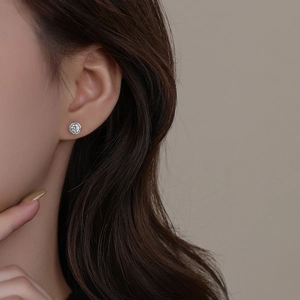 Minimalist S999 sterling silver stud earrings with sparkling round cubic zirconia on model
