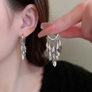 Exaggerated silver leaf fringe drop earrings with layered metallic tassels and ear buckle