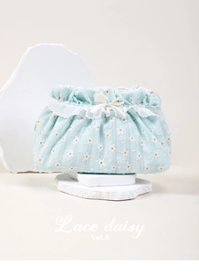 Detail of light blue daisy cosmetic bag with lace trim and elegant ribbon bow decoration