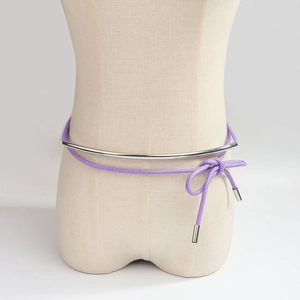 Detail of silver metal bar waist belt with purple rope tie knotted on a mannequin
