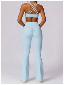 Detail of light blue yoga set featuring a cross-back sports bra and scrunch butt flare pants