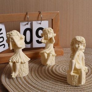 Three-piece set of little girl figurines on tree stumps with see-hear-speak no evil poses