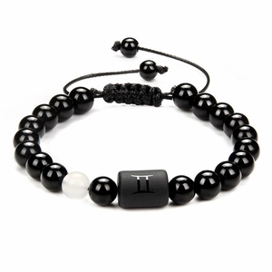Detail of Gemini black onyx beaded bracelet with white bead and adjustable cord