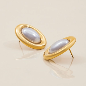 Macro view of vintage style 18K gold stainless steel earrings with grey oval pearls