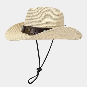 Detail of straw cowboy hat featuring leather band with bull head and turquoise studs
