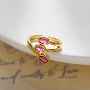 Detail of gold-plated triple pink zircon stones on a stainless steel open ring