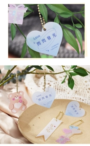 Detailed macro view of heart and bear shaped acrylic tags with elegant metal chains